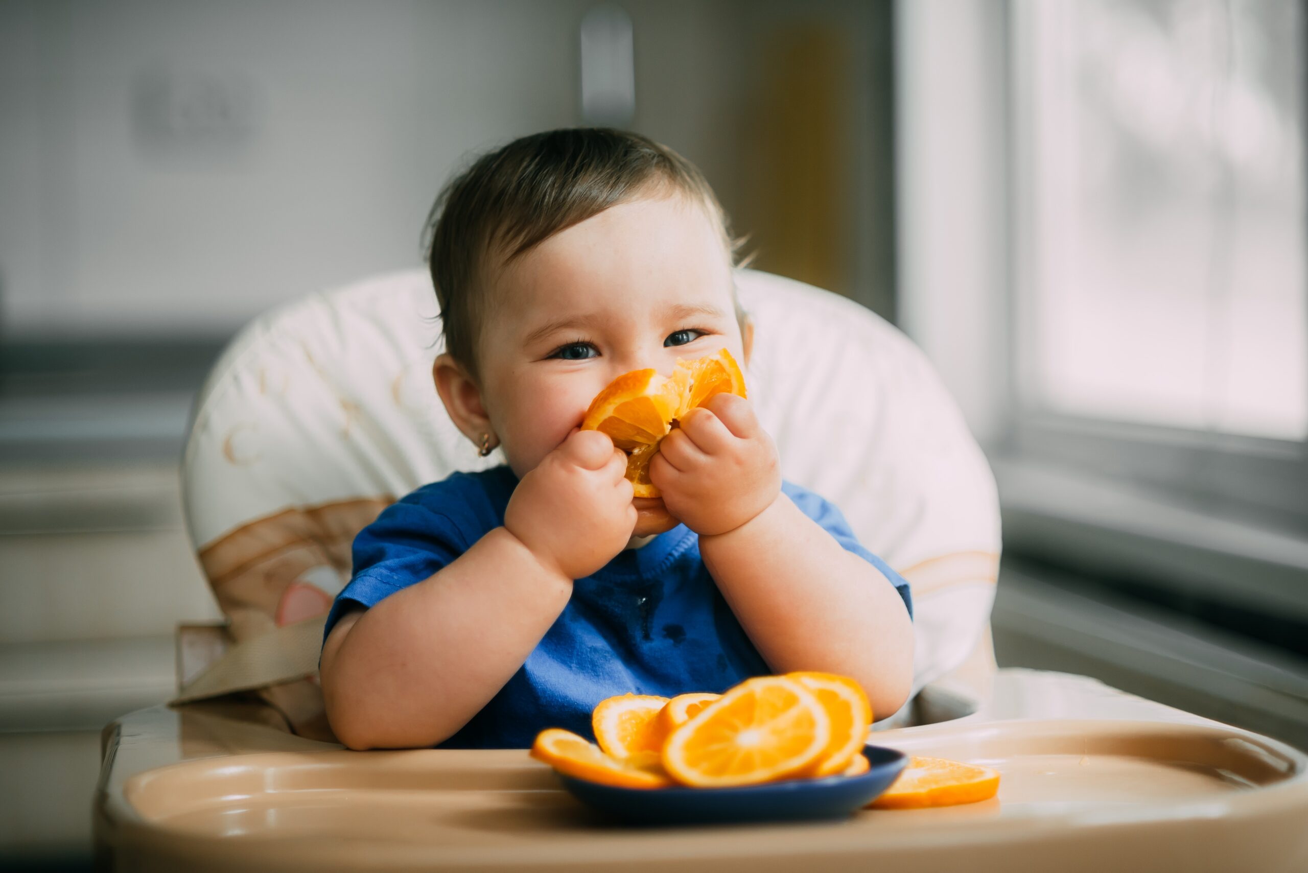 girl eating an orange slice