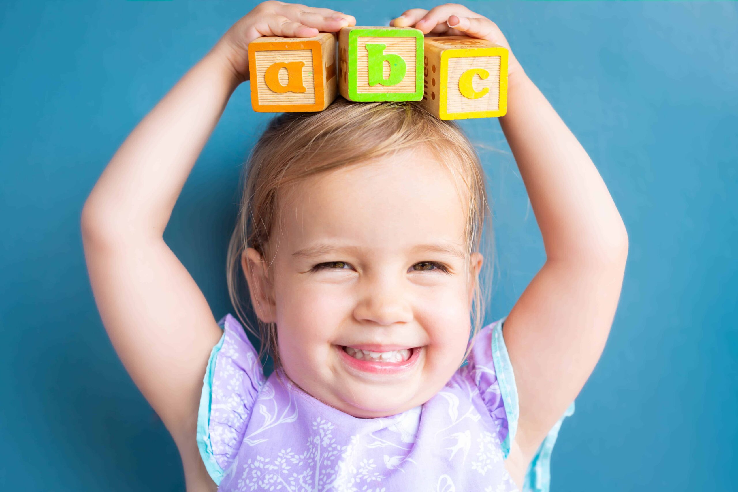 girl holding building blocks