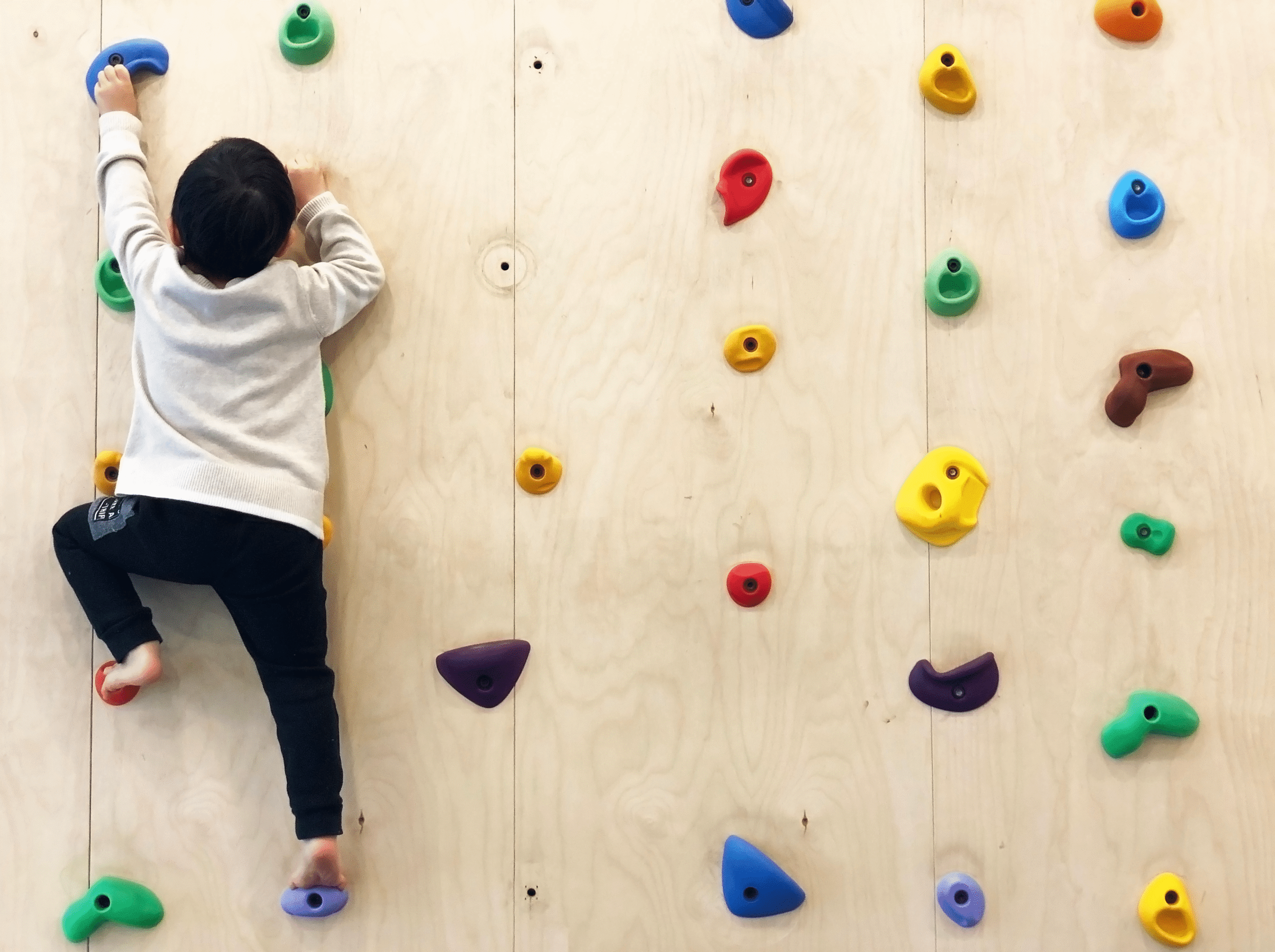 young kid climbing wall