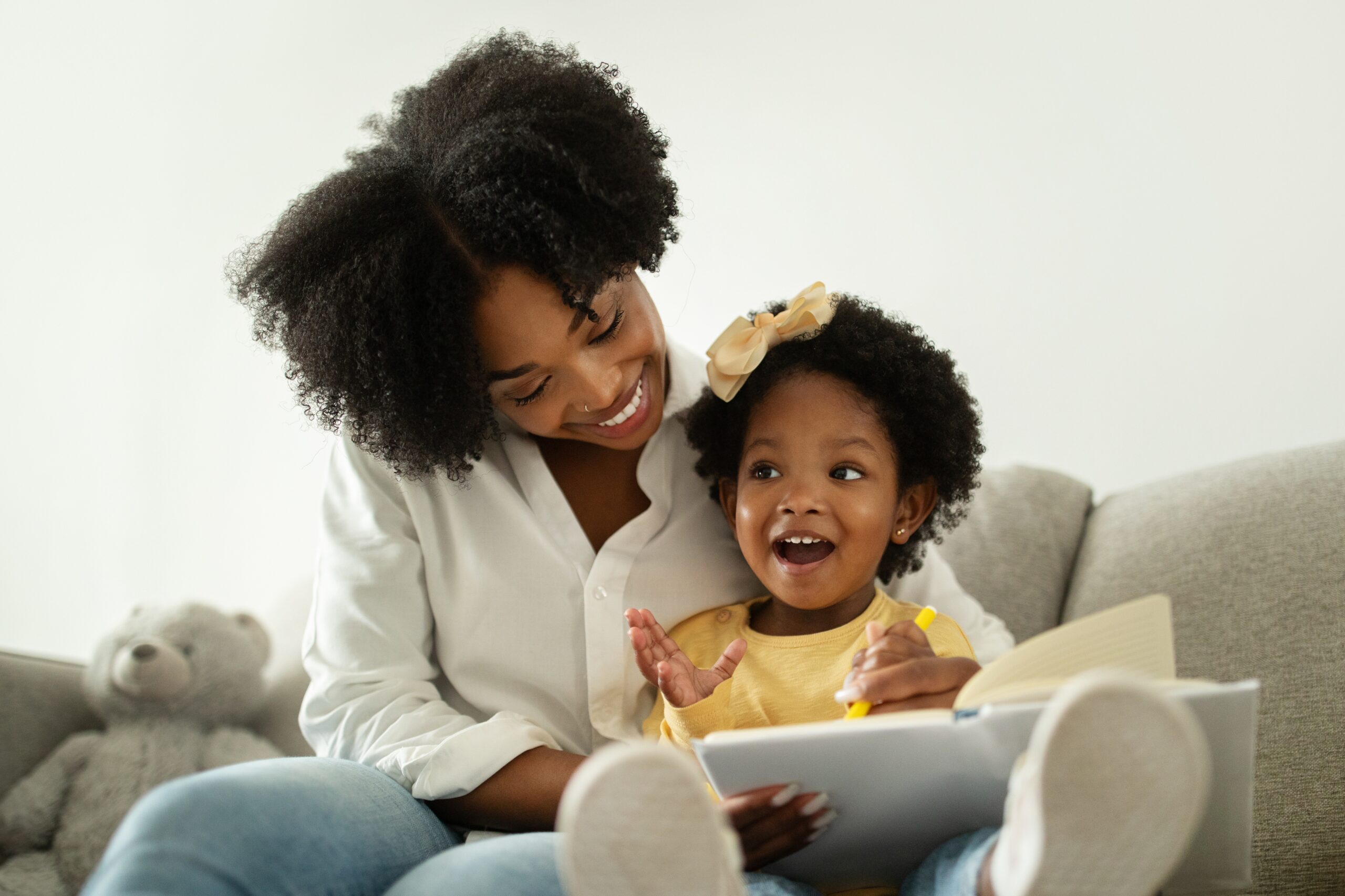 young girl reading with her mom