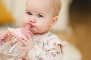 toddler drinking from a sippy cup