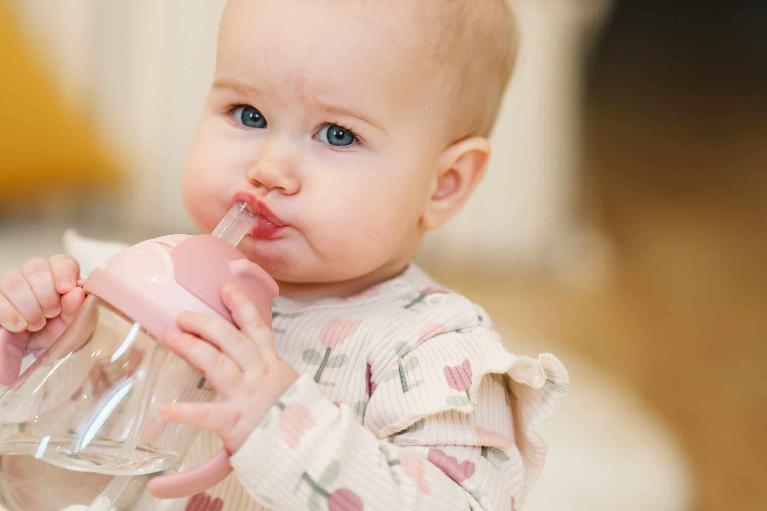 toddler drinking from a sippy cup