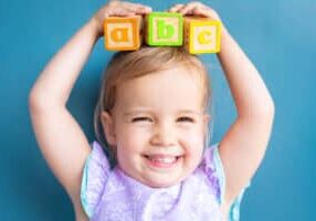 A,Cute,Little,Girl,Balancing,Abc,Alphabet,Blocks,On,Her